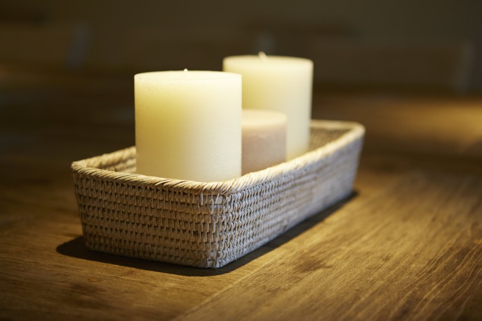Three candles in a wicker candle holder