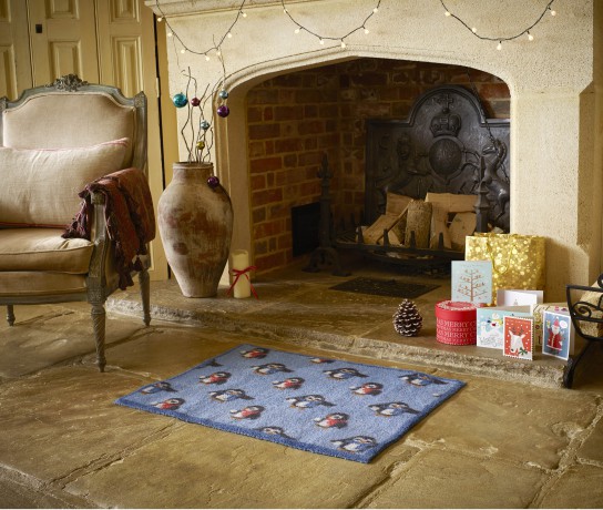 Blue Penguin Turtle Mat in front of fireplace